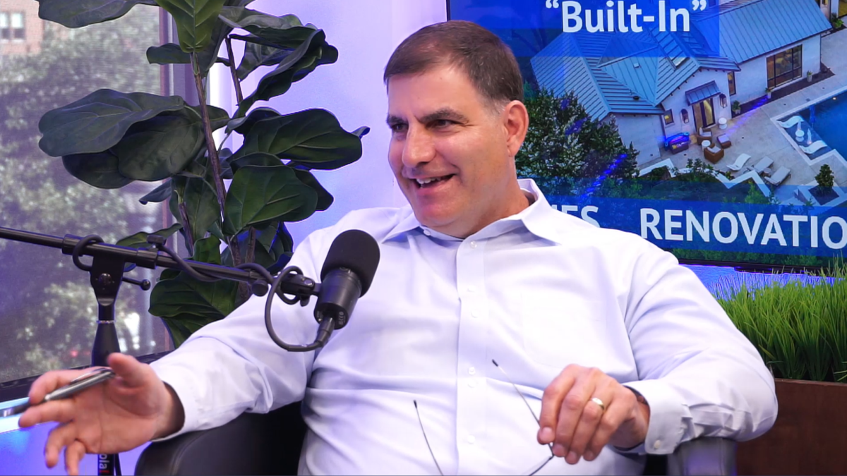 Mike Garabedian, a custom home builder, speaking into a microphone during a recorded podcast on Uniqueness... "Built-In"
