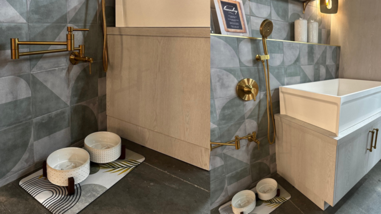 Wall-mounted brass pot filler installed low to the floor for filling dog water bowls, set against patterned tile with custom cabinetry in a utility space.