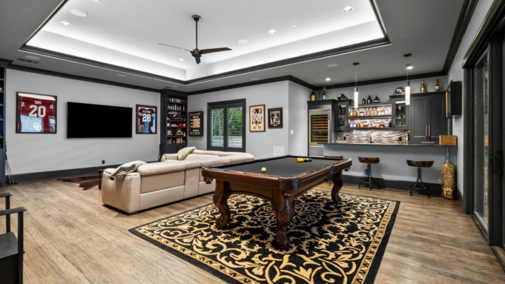 Custom game room with pool table and custom bar.