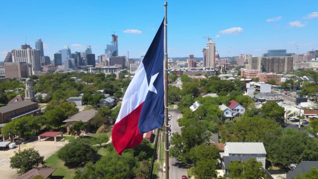 Photo of Texas Flag with the city of Southlake behind it.