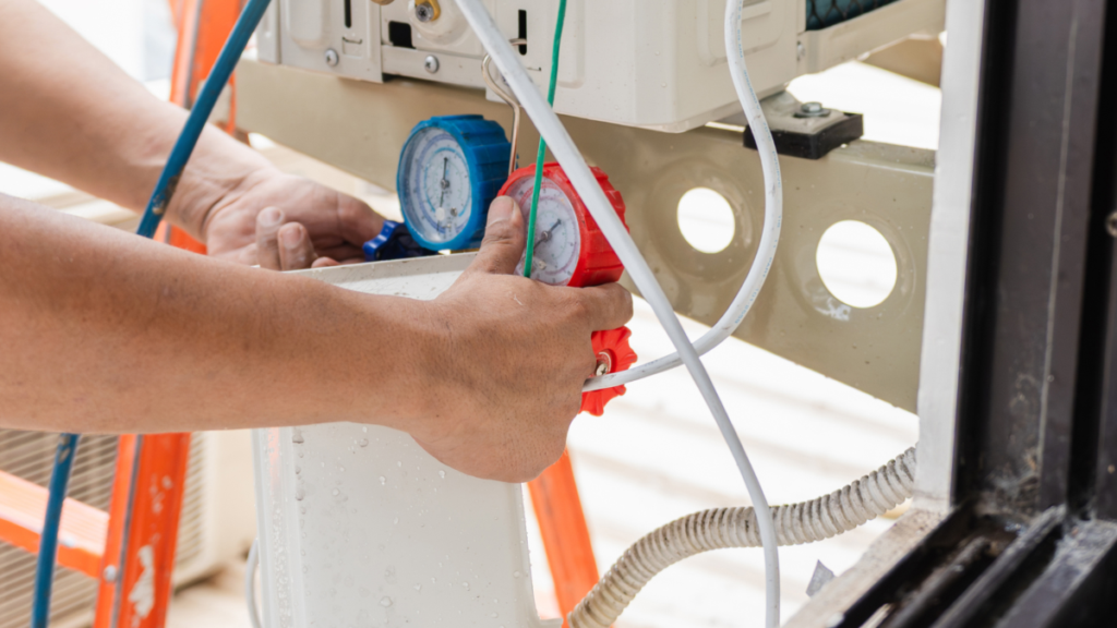 Technician inspecting HVAC unit with manifold gauges and refrigerant lines.