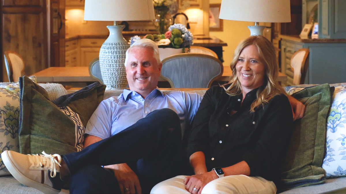 Married couple sitting on couch giving a custom home builder reviews about Garabedian Properties.