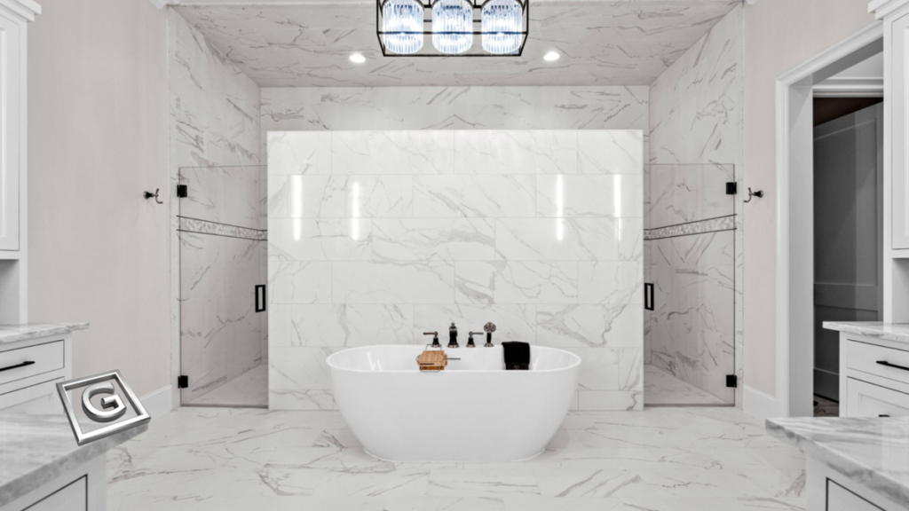 Garabedian Properties premier residential builder North Texas — floor-to-ceiling white marble primary bathroom with continuous stone veining across walls, ceiling, and floors, freestanding soaking tub centered between frameless glass shower enclosures, and a statement crystal chandelier overhead